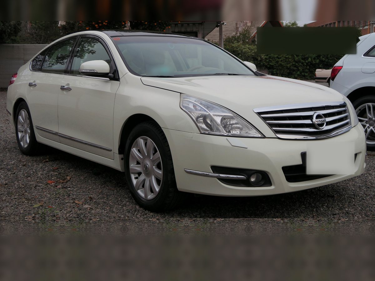 Example photo: white Nissan Teana 2009, front three-quarter view. Not the actual car.